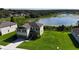Aerial view of a house with a lake view at 11430 Wishing Well Ln, Clermont, FL 34711