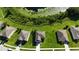 Aerial view showcasing houses and a pond at 11430 Wishing Well Ln, Clermont, FL 34711