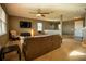 Living room with ceiling fan, couch, and view to entryway at 11430 Wishing Well Ln, Clermont, FL 34711