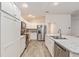 Modern kitchen with white cabinets, granite countertops, and stainless steel appliances at 11394 Zimmerman Path, Oxford, FL 34484
