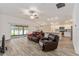 Living room with sliding glass doors and comfortable seating at 11394 Zimmerman Path, Oxford, FL 34484