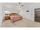 Main bedroom with carpeted floor and ceiling fan at 11394 Zimmerman Path, Oxford, FL 34484