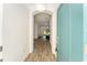 Bright entryway with teal door and view into the living area at 11394 Zimmerman Path, Oxford, FL 34484