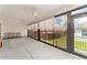 Covered screened porch with multiple ceiling fans and outside access at 11394 Zimmerman Path, Oxford, FL 34484