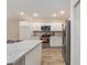 Modern kitchen with white cabinets, granite countertops, and stainless steel appliances at 11394 Zimmerman Path, Oxford, FL 34484