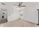 Spacious bedroom with ceiling fan and window at 11394 Zimmerman Path, Oxford, FL 34484