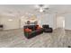 Open concept living room with kitchen views and recliners at 11394 Zimmerman Path, Oxford, FL 34484