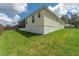View of the house's side and backyard, showing ample green space at 11394 Zimmerman Path, Oxford, FL 34484