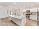 Modern kitchen with white cabinets, granite countertops, and stainless steel appliances at 11394 Zimmerman Path, Oxford, FL 34484
