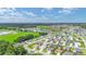 Aerial view of a beautiful community with lush green spaces and numerous homes at 11394 Zimmerman Path, Oxford, FL 34484
