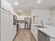 Modern kitchen with white cabinets, granite countertops, and stainless steel appliances at 11394 Zimmerman Path, Oxford, FL 34484