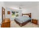 Spacious bedroom with wood furniture and large window at 11394 Zimmerman Path, Oxford, FL 34484