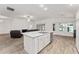Modern kitchen with white cabinets, granite countertops, and stainless steel appliances at 11394 Zimmerman Path, Oxford, FL 34484