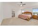 Spacious main bedroom with carpeted floor and ceiling fan at 11394 Zimmerman Path, Oxford, FL 34484