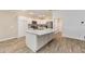 Modern kitchen with white cabinets, granite countertops, and stainless steel appliances at 11394 Zimmerman Path, Oxford, FL 34484
