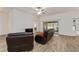Spacious living room with leather recliners and sliding glass doors leading to a patio at 11394 Zimmerman Path, Oxford, FL 34484