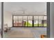 Relaxing screened porch with ceiling fan, offering backyard views at 11394 Zimmerman Path, Oxford, FL 34484