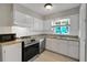 Updated kitchen with white cabinets and granite countertops at 11635 Se Highway 42, Weirsdale, FL 32195