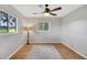 Spacious bedroom featuring wood floors, a ceiling fan, and ample natural light at 11635 Se Highway 42, Weirsdale, FL 32195