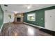 Living room with wood-look floors, fireplace, and green walls at 11635 Se Highway 42, Weirsdale, FL 32195