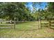 Chain link and wooden fence with open gate at 11635 Se Highway 42, Weirsdale, FL 32195