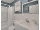 Updated bathroom, featuring a white vanity, tub shower, and a medicine cabinet at 11635 Se Highway 42, Weirsdale, FL 32195