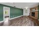 Spacious living area with wood-look floors and a fireplace at 11635 Se Highway 42, Weirsdale, FL 32195