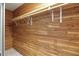 Spacious walk-in closet with wood paneling and ample shelving at 11635 Se Highway 42, Weirsdale, FL 32195