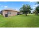 Spacious backyard with green lawn and trees at 3506 Mulberry Grove Loop, Leesburg, FL 34748