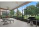 Relaxing screened porch with seating and grill at 3506 Mulberry Grove Loop, Leesburg, FL 34748