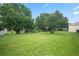 Large backyard with green grass and mature trees at 3506 Mulberry Grove Loop, Leesburg, FL 34748