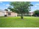 Backyard view of home with lush green grass at 3506 Mulberry Grove Loop, Leesburg, FL 34748