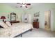 Spacious bedroom with a king-size bed and ensuite bathroom access at 3506 Mulberry Grove Loop, Leesburg, FL 34748
