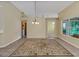 Well-lit dining room featuring tile floors and access to adjacent rooms at 3912 Plantation Blvd, Leesburg, FL 34748