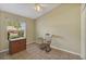 Bright bedroom with tile flooring, a ceiling fan, and a window with blinds at 3912 Plantation Blvd, Leesburg, FL 34748