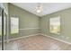 Spacious bedroom with tile floors and two windows with blinds at 3912 Plantation Blvd, Leesburg, FL 34748