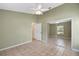 Large bedroom with tile floors, mirrored closet doors, and access to a bathroom at 3912 Plantation Blvd, Leesburg, FL 34748