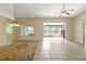 Bright dining room with tile floors, a ceiling fan, and access to a screened porch at 3912 Plantation Blvd, Leesburg, FL 34748
