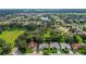 Aerial view of a neighborhood with homes and green spaces at 3912 Plantation Blvd, Leesburg, FL 34748
