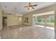 Open living room and sunroom with tile floors and access to the kitchen at 3912 Plantation Blvd, Leesburg, FL 34748