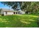 Large backyard with lush grass and shade trees at 3912 Plantation Blvd, Leesburg, FL 34748