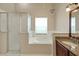 Bathroom with granite countertops, a garden tub, and a walk-in shower at 3912 Plantation Blvd, Leesburg, FL 34748