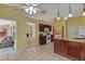 Eat-in kitchen with granite counters, wood cabinets, and views to the Gathering room at 3912 Plantation Blvd, Leesburg, FL 34748