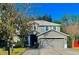 Two-story house with gray siding, a two-car garage, and landscaping at 1245 Reagans Reserve Blvd, Apopka, FL 32712