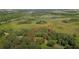 Aerial view showing a lot surrounded by lush greenery and a nearby highway at 450 Long And Winding Rd, Groveland, FL 34737