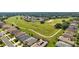 Wide aerial view of houses and a golf course at 27227 Roanoke Dr, Leesburg, FL 34748