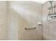 Shower stall with beige tile and grab bar at 27227 Roanoke Dr, Leesburg, FL 34748