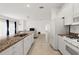 Open concept kitchen with granite countertops and island at 27227 Roanoke Dr, Leesburg, FL 34748