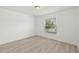 Bright bedroom with wood-look floors and a window at 27227 Roanoke Dr, Leesburg, FL 34748