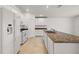 White kitchen features granite countertops and island at 27227 Roanoke Dr, Leesburg, FL 34748
